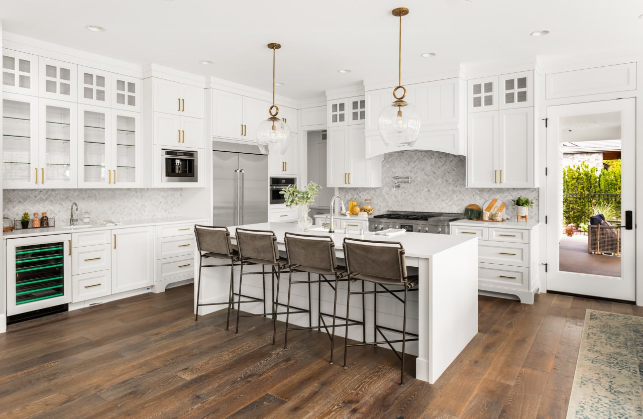 Bright kitchen with dark hardwood flooring