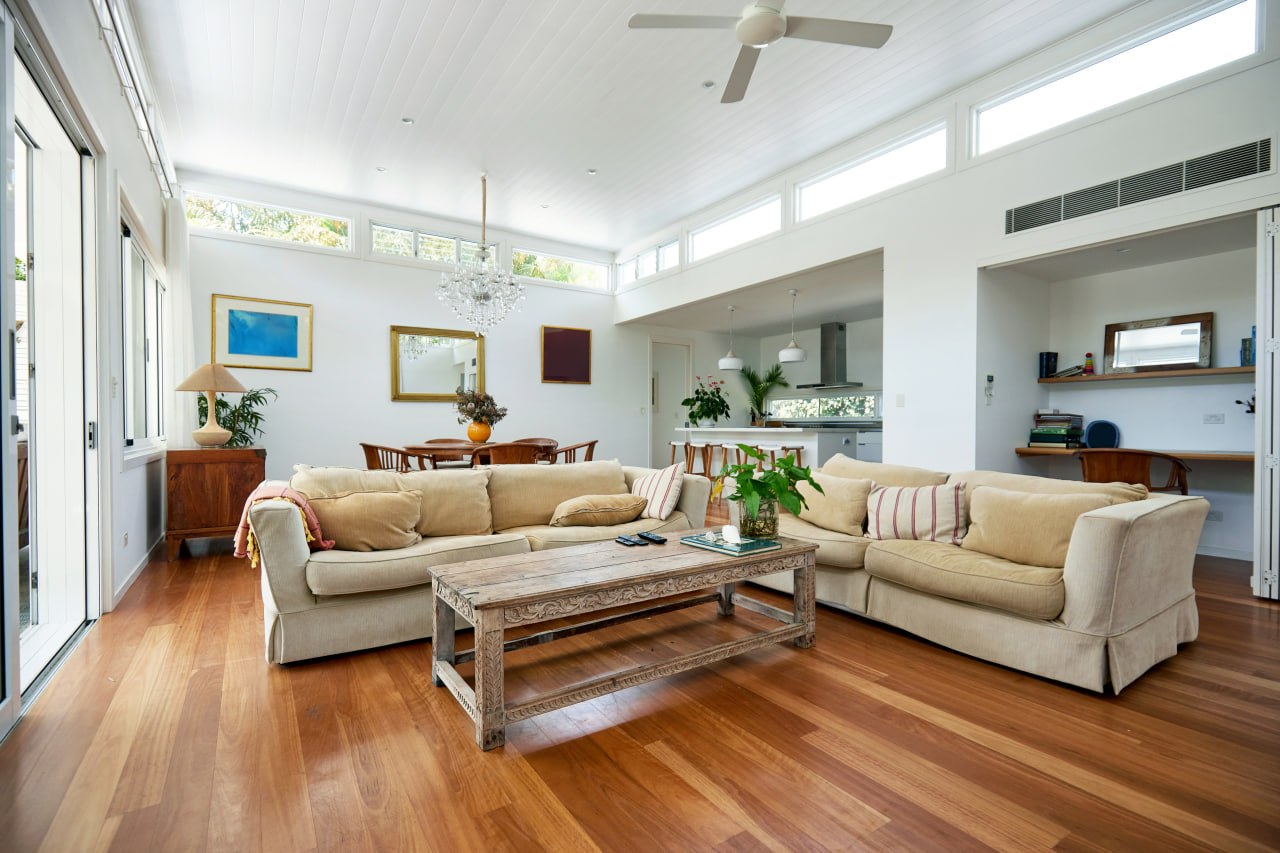 Open-concept living area with warm wood-look flooring